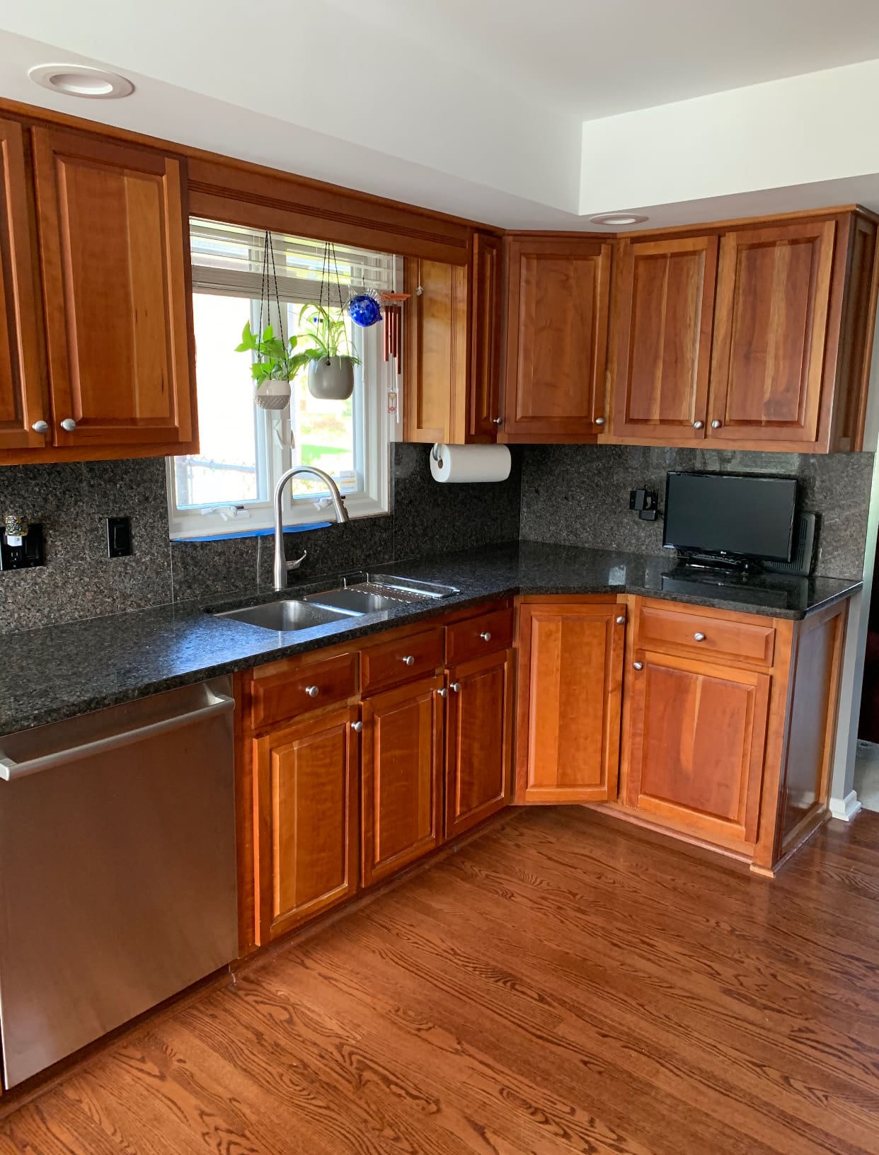 A kitchen with wooden cabinets and floors