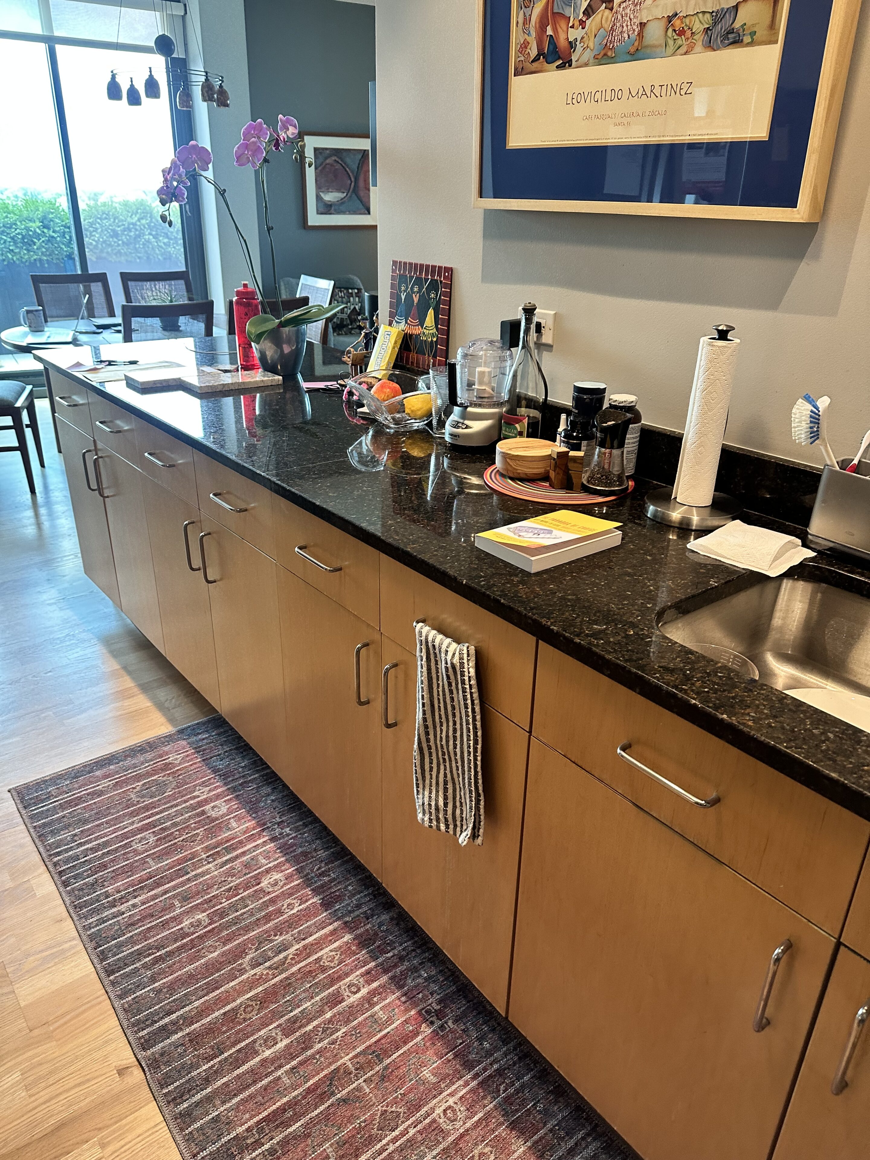 A kitchen with a lot of counter space and dishes on the table.