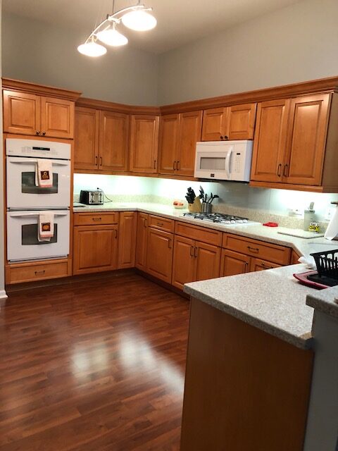 A kitchen with wooden cabinets and white appliances.