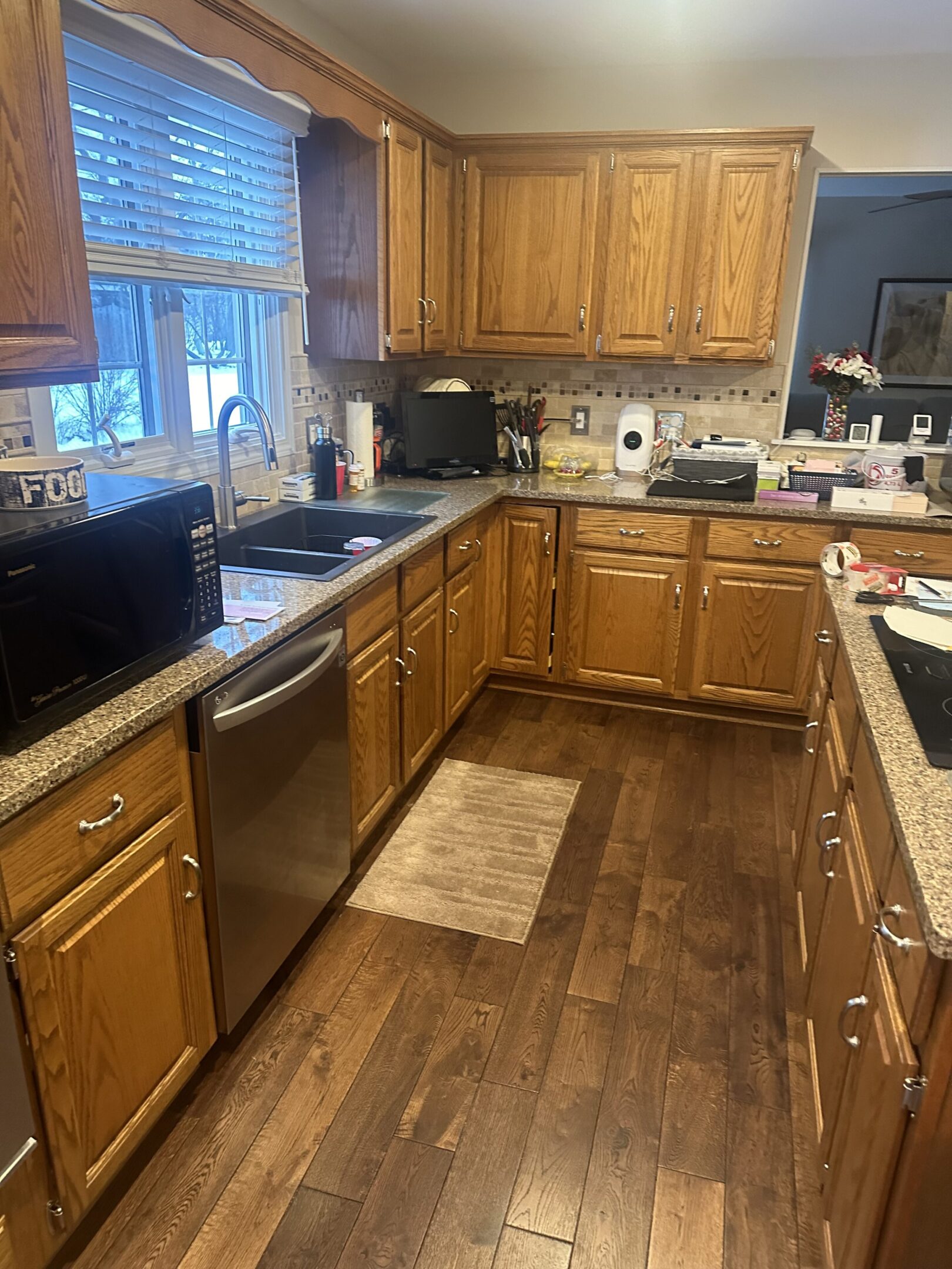 A kitchen with wooden cabinets and floors