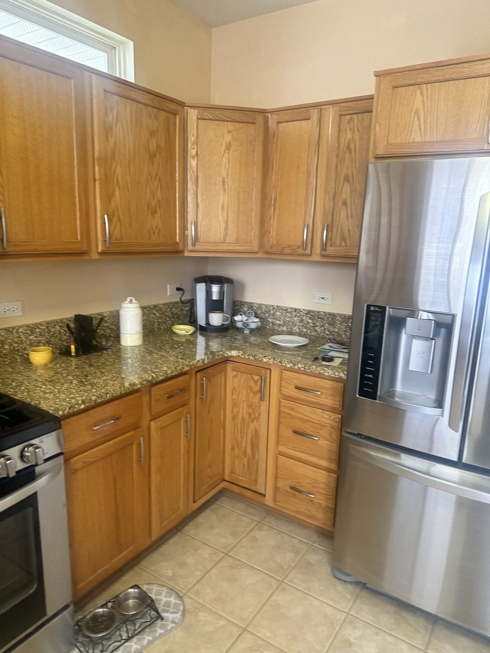 A kitchen with wooden cabinets and granite counter tops.