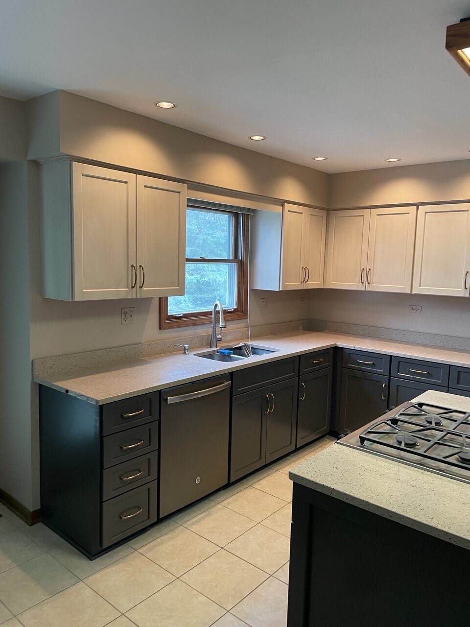 A kitchen with white cabinets and black cupboards